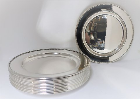 Georg Jensen. Sterling (925). 12 pieces silver cover plates. Hammered. Design 
210F. Diameter 26 cm.