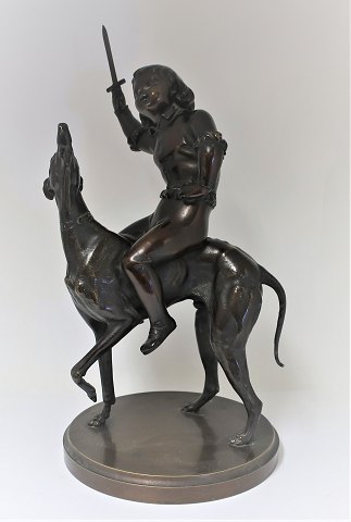 Bronze figure. Boy sitting on greyhound. Height 45 cm.
