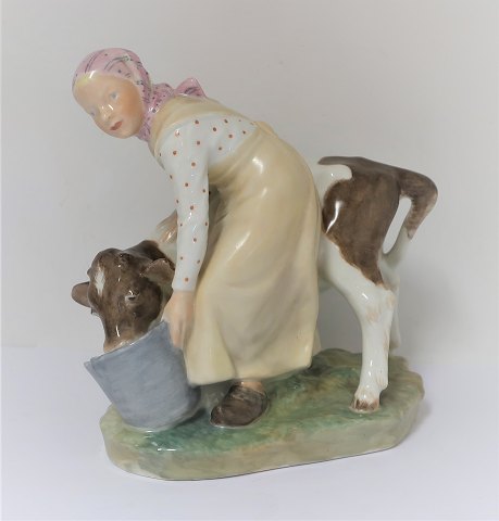 Royal Copenhagen. Porcelain figure. Girl with cow in colors. Model 779. Height 
16 cm. (1 quality).