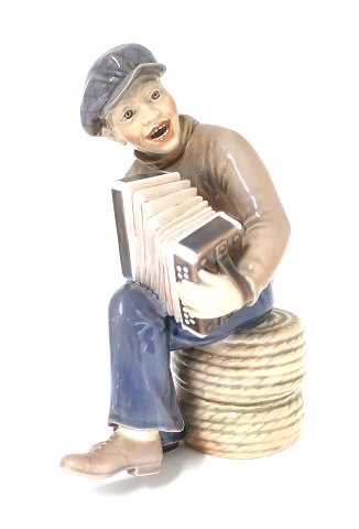 Dahl Jensen. Harmonica playing boy. Model # 1154. Height 22 cm. (1 quality)