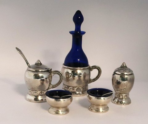 Danish work. Silver (830). 2 salt jars with spoons, pepper shaker, mustard jar 
and vinegar bottle. 7 parts. Produced 1918.