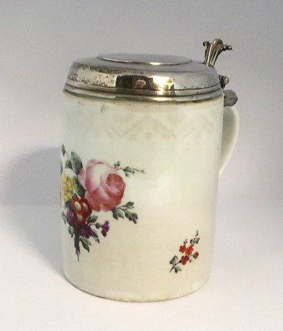 Royal Copenhagen. Lidded mug decorated with flowers with silver lid. Lid not 
stamped. Height 17 cm. Diameter 12 cm