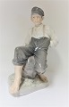 Royal Copenhagen. Sitting shepherd. Model 1659. Height 31 cm. (1 quality)